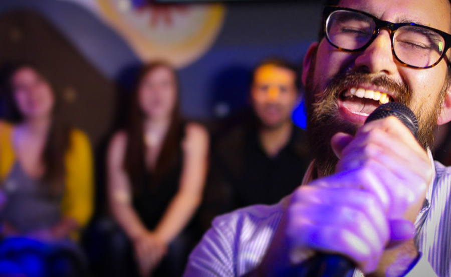 Man With Glasses Singing Karaoke - Planning A Class Reunion