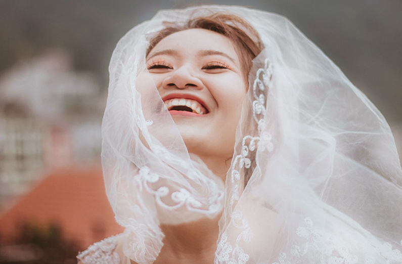 Wedding Makeup - Smiling Bride Wearing Veil