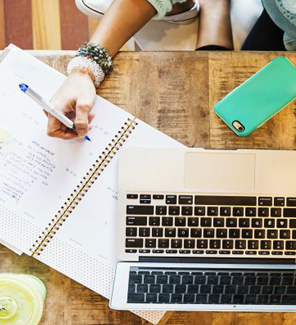 Wedding Planning - Woman Making Notes With Phone And Laptop