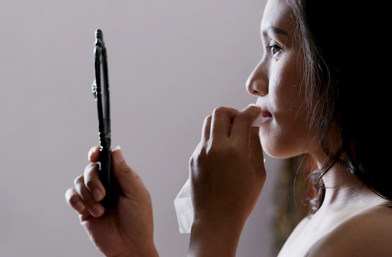 Wedding Makeup - Woman Blotting Her Makeup And Looking at Mirror