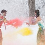 Wedding Dress Traditions - Trash The Dress - Bride And Groom Throwing Colored Powder In The Snow