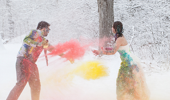 Wedding Dress Traditions - Trash The Dress - Bride And Groom Throwing Colored Powder In The Snow