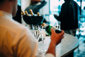 Server pouring champagne